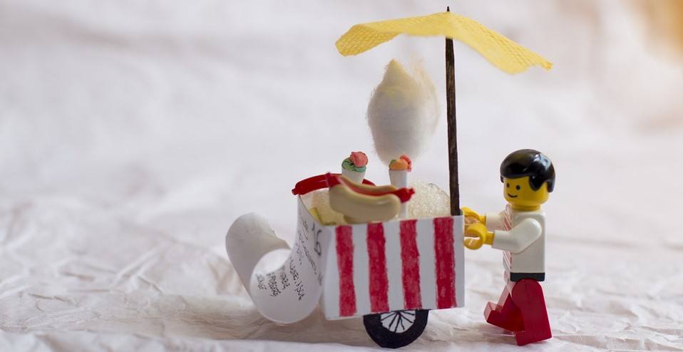 A LEGO pushing around a hot dog stand (with ice cream)